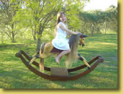 Sienna riding a restoired rocking horse